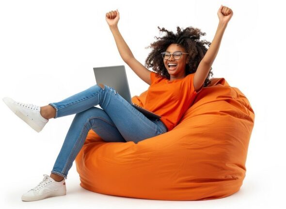 Excited woman using laptop joyfully